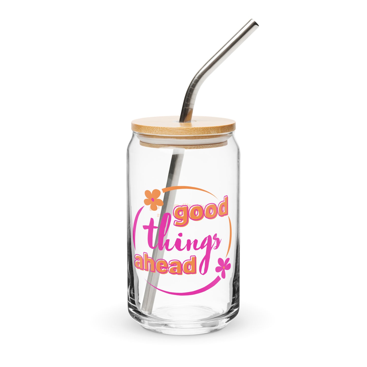 A clear glass can-shaped drinking glass with a bamboo lid and a stainless steel straw. The glass has 'Good Things Ahead' printed in orange and white flowers.