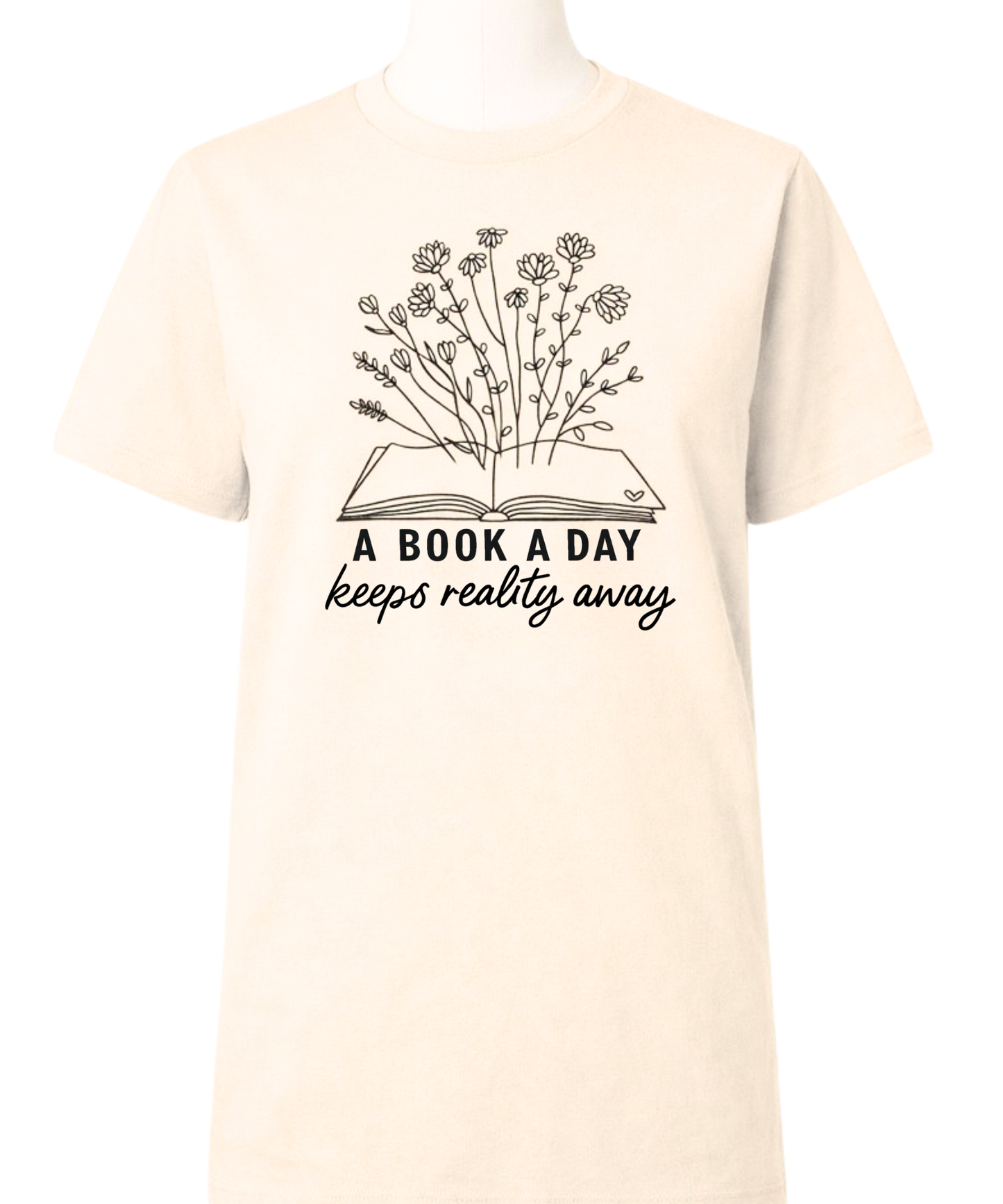Beige t-shirt with a graphic of an open book with flowers and text 'A book a day keeps reality away' on a white background.