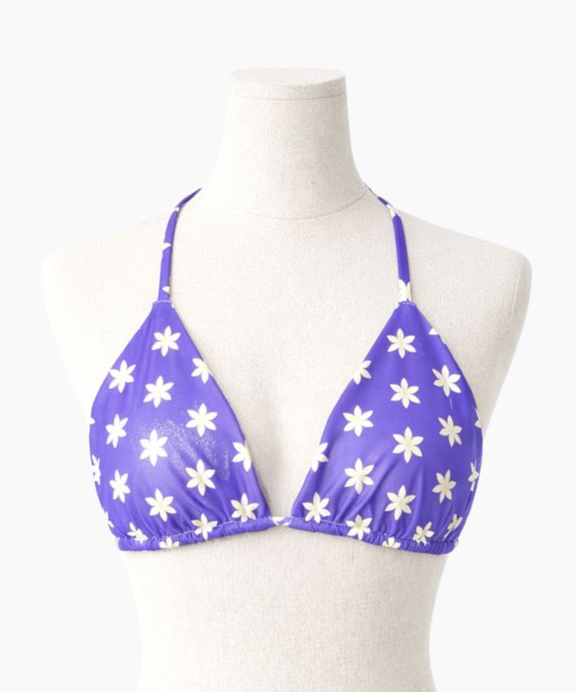 Purple bikini top with a light yellow floral pattern on a mannequin against a white background