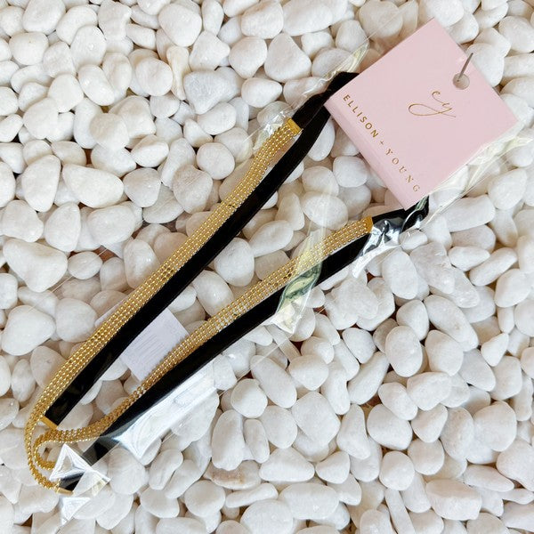 Elevate your style with the Tied in Gold Choker-Style Necklace by Ellison and Young. Featuring a delicate gold chain complemented by a chic black velvety ribbon tie, this versatile accessory adds a touch of elegance to any outfit. Perfect for day-to-night transitions, it effortlessly blends timeless sophistication with modern flair.
