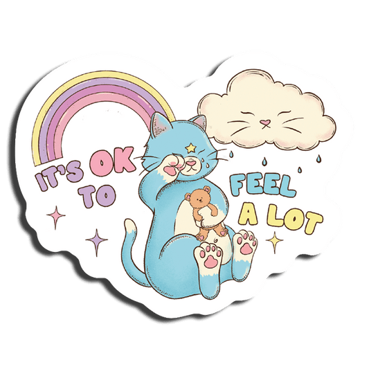 A die-cut sticker featuring a blue cat with a teddy bear, with rainbows and a cloud in the background. The text 'It's OK to Feel A Lot' is also present.